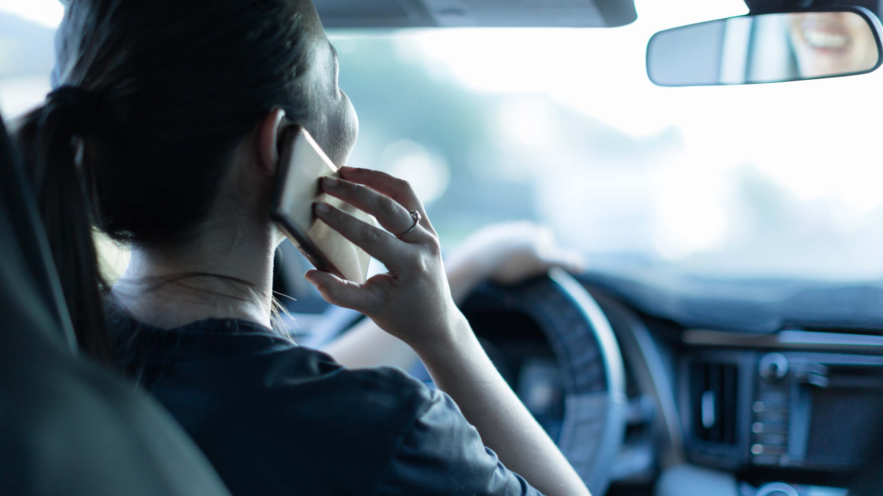 Person distracted on a call with their cellphone while driving