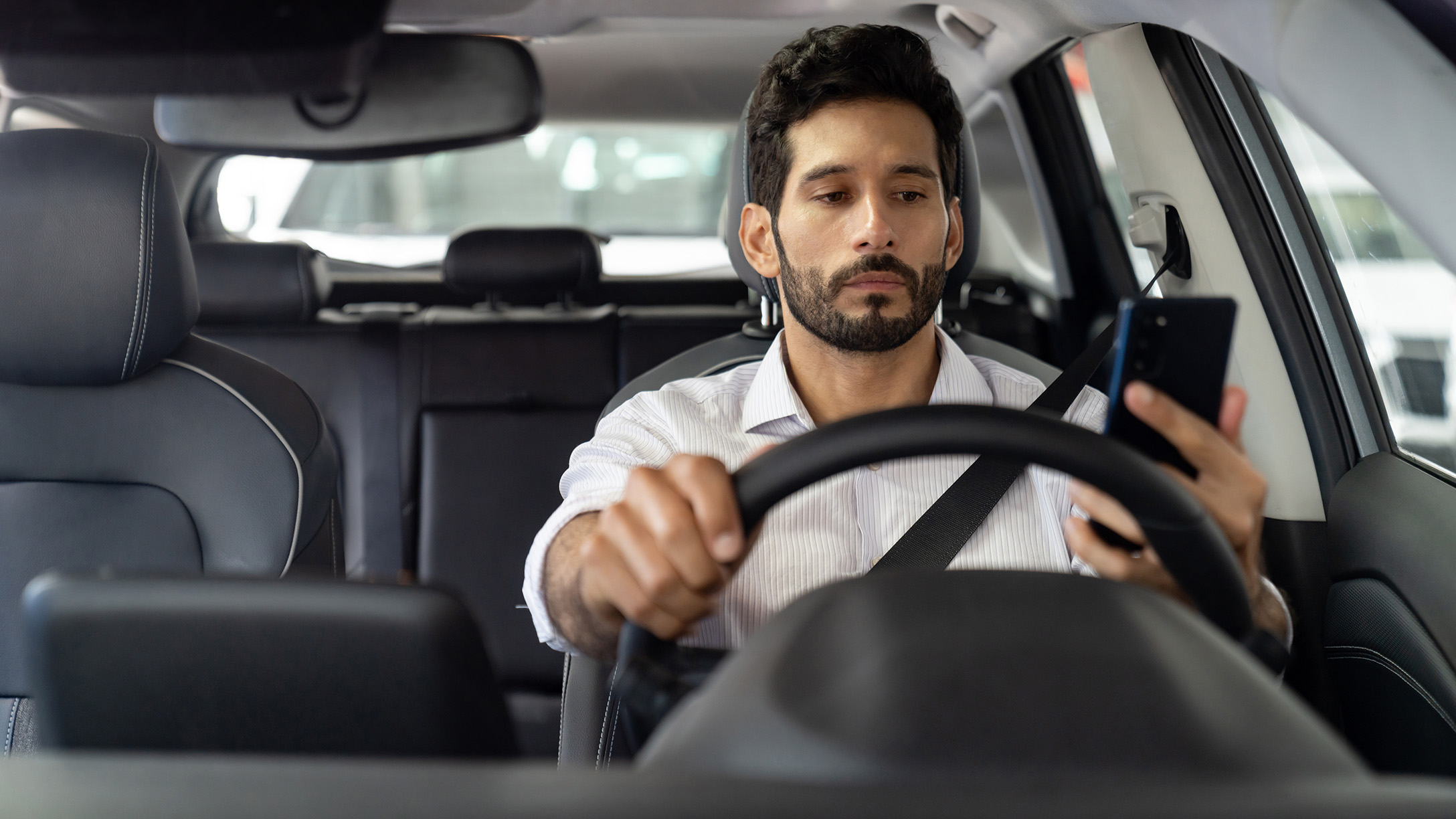 driver distracted checking their phone 