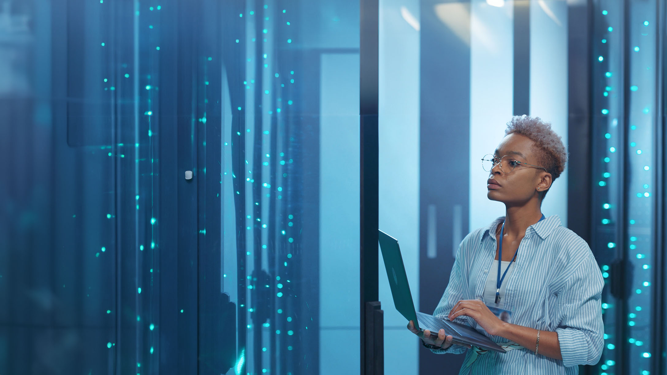 Woman with laptop working in data center with AI