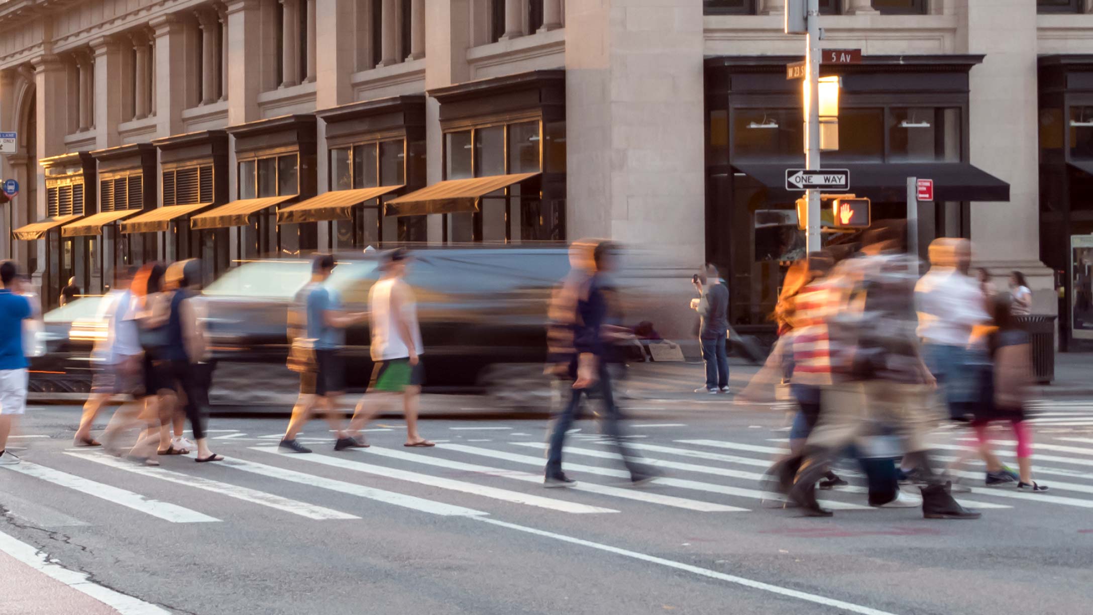 Picture of a street with people crossing the road