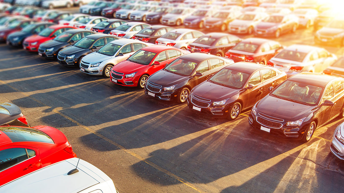 Dozens of vehicles parked on an outdoor parking lot