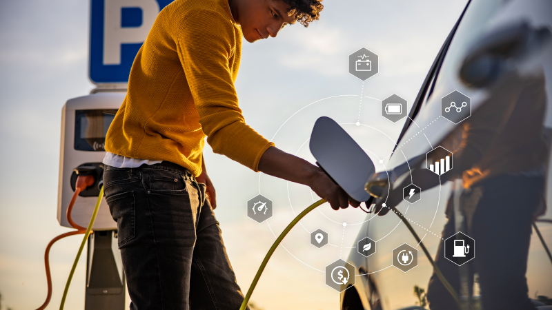 Young man charging EV vehicle