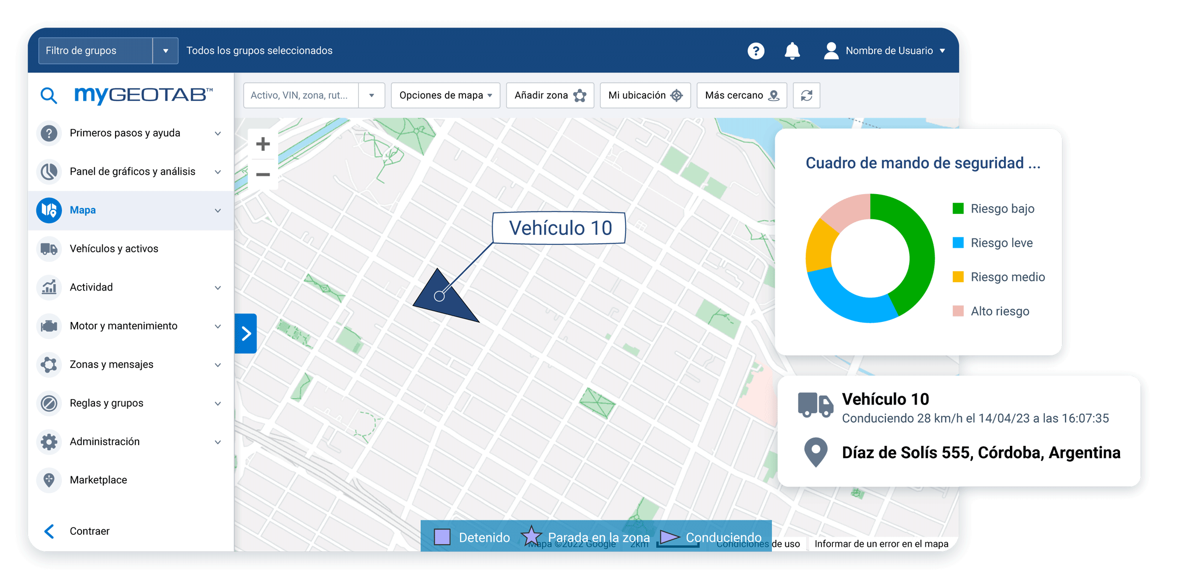 White laptop displaying MyGeotab map with vehicle data and driver safety scorecard overlaying the screen.
