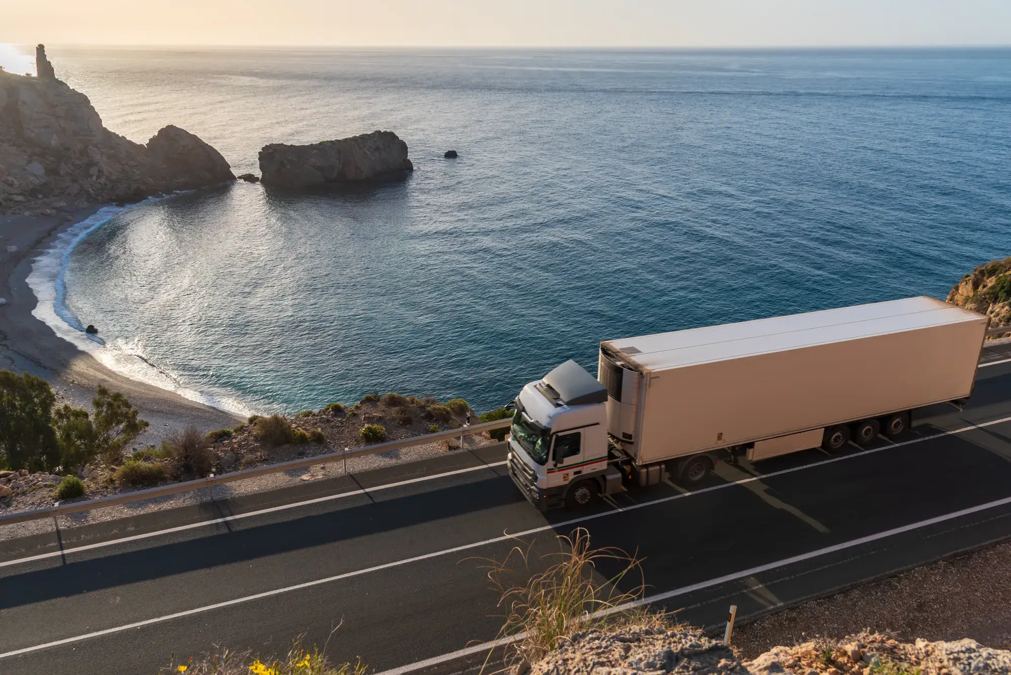 truck on a highway by the ocean