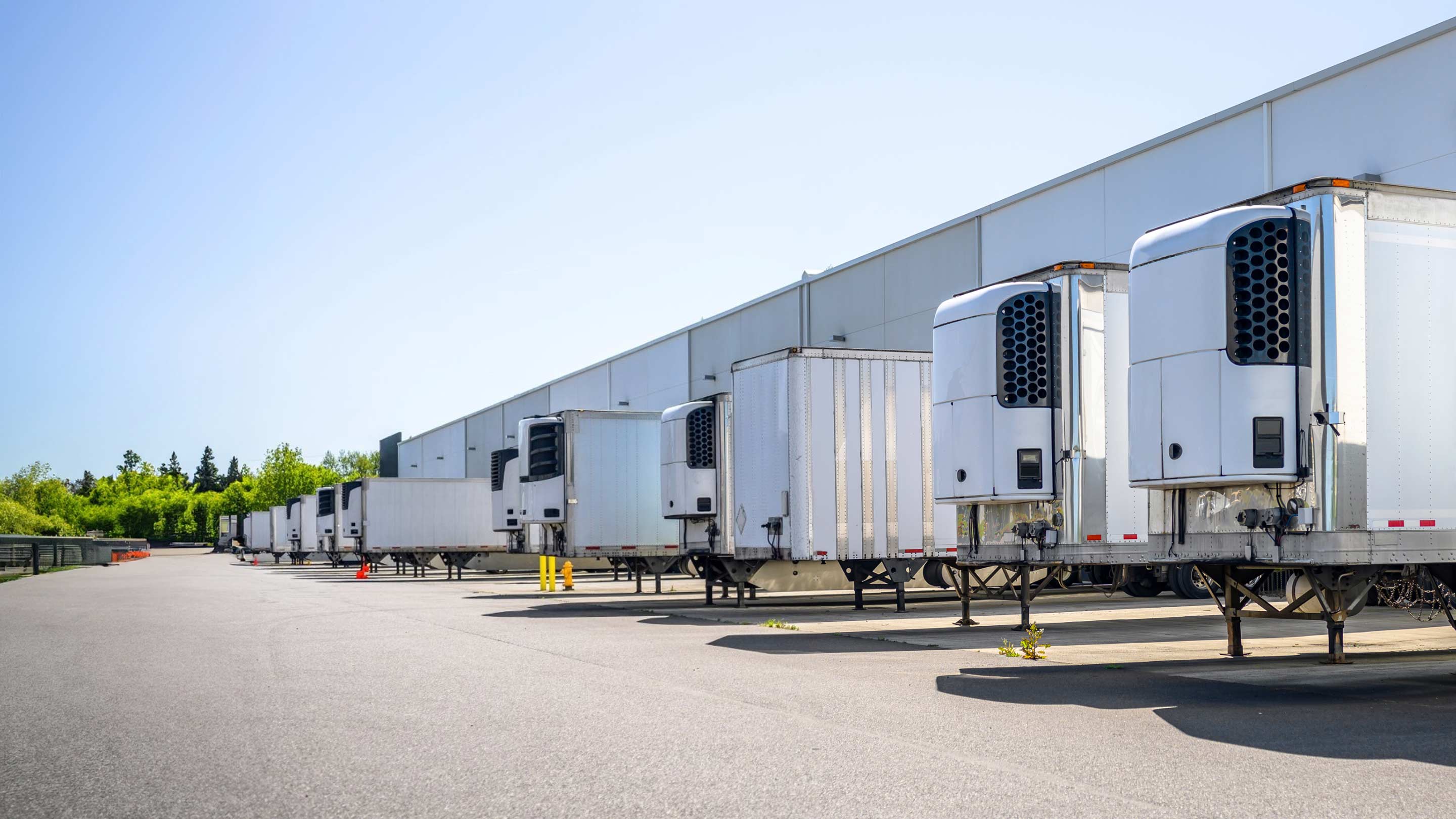 Trailers parked at a warehouse disconnected from trucks