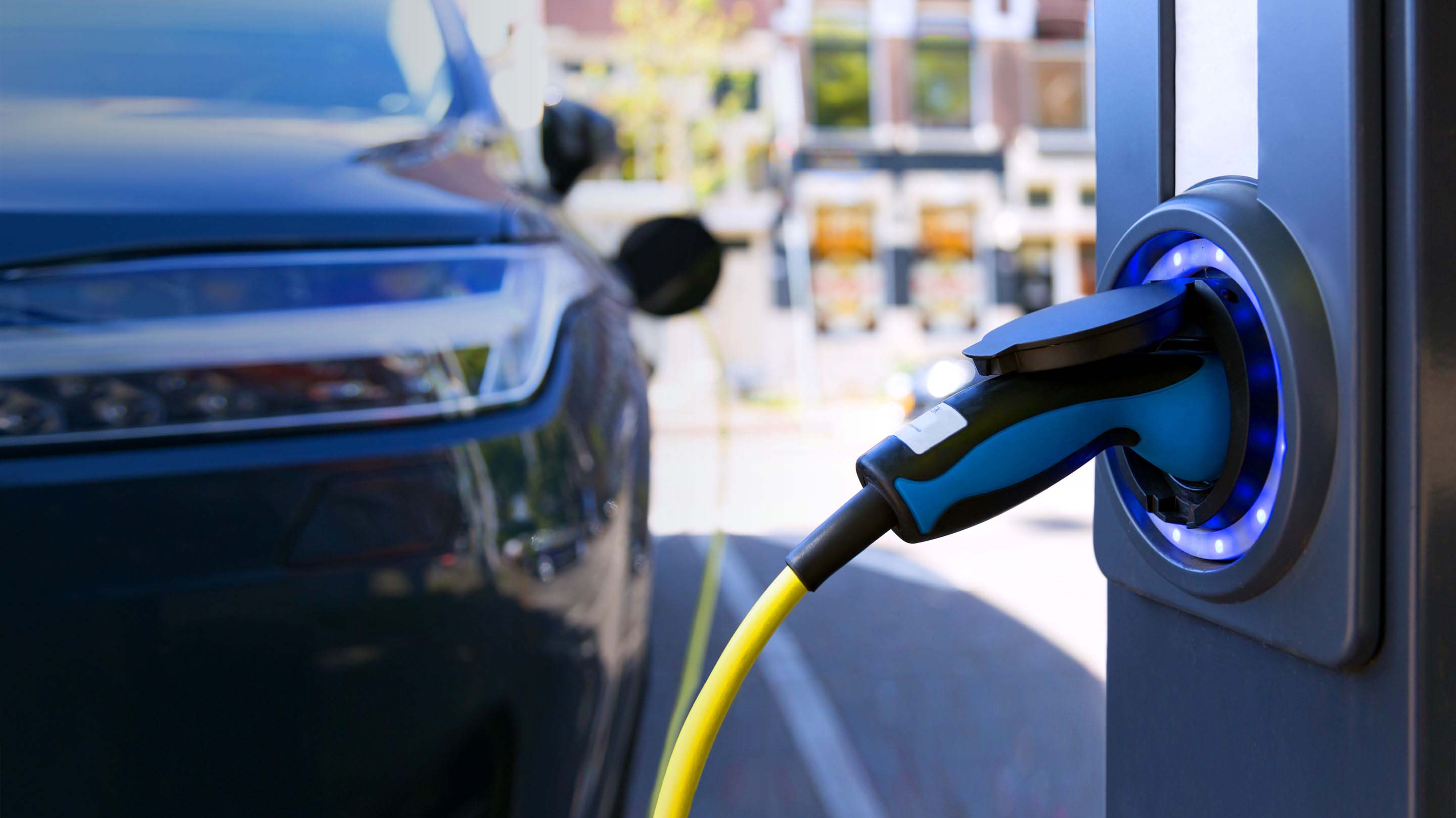 Electric vehicle being charged at charging station