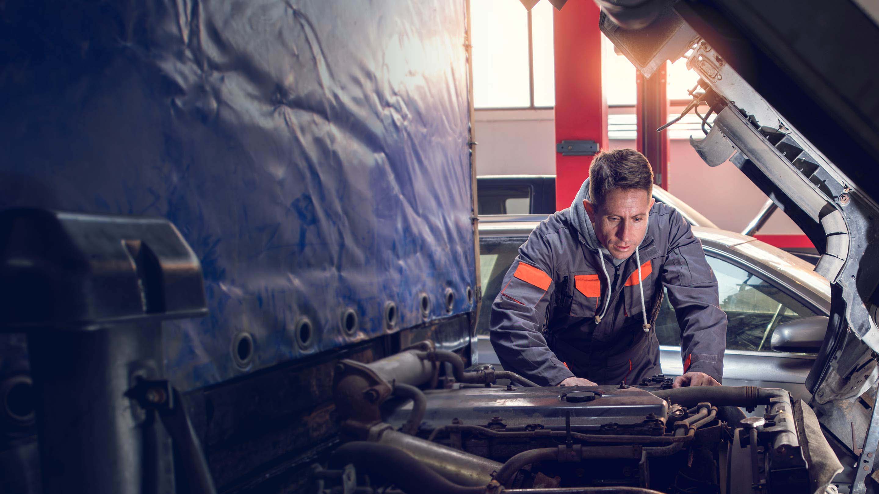 Man performing maintenance in vehicle