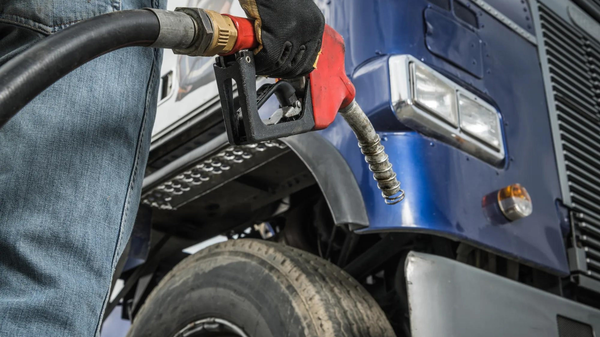 person filling fuel in truck