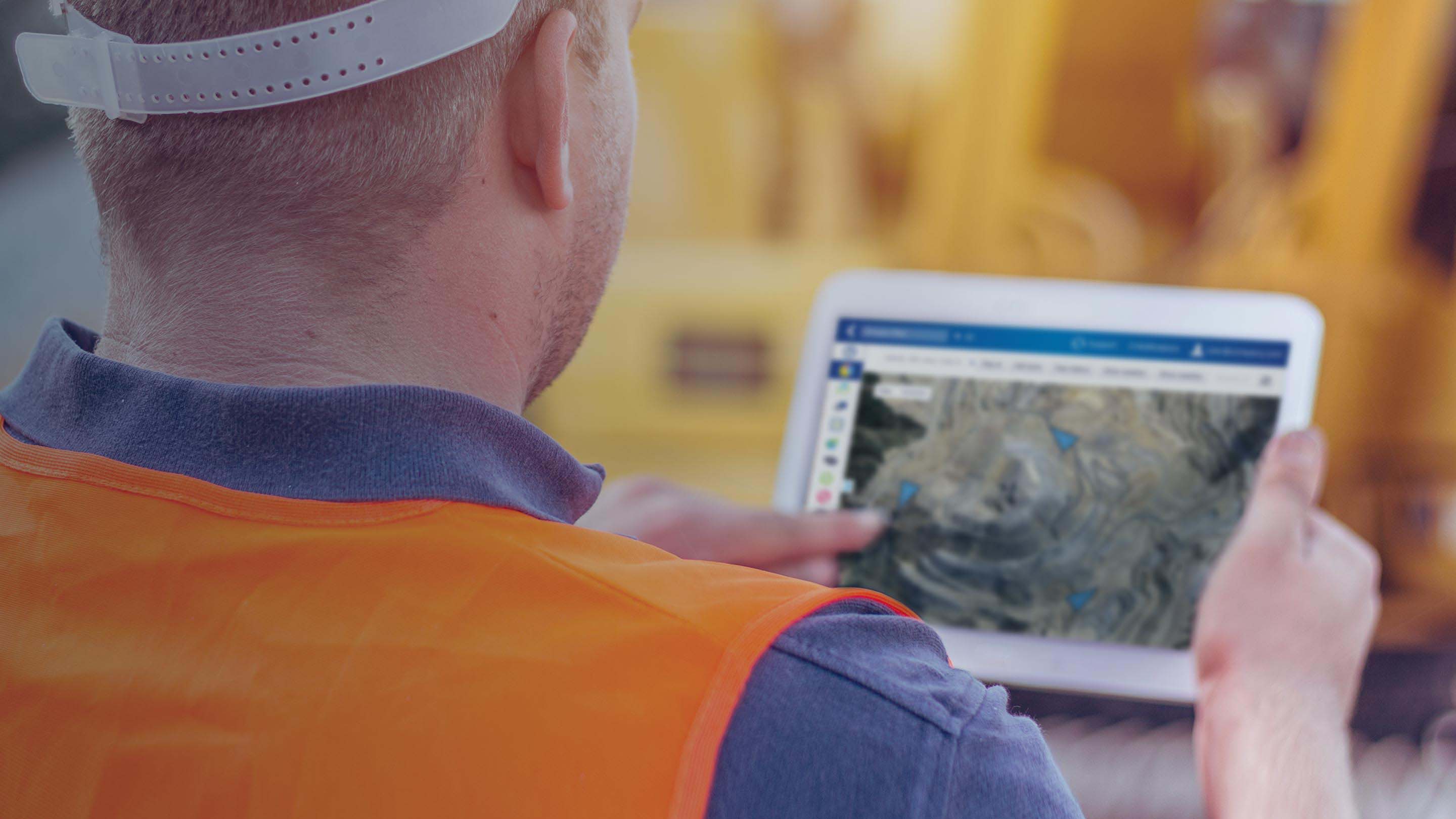 Construction worker using a tablet with MyGeotab interface