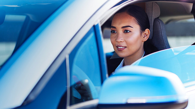 Woman sitting in a silver car