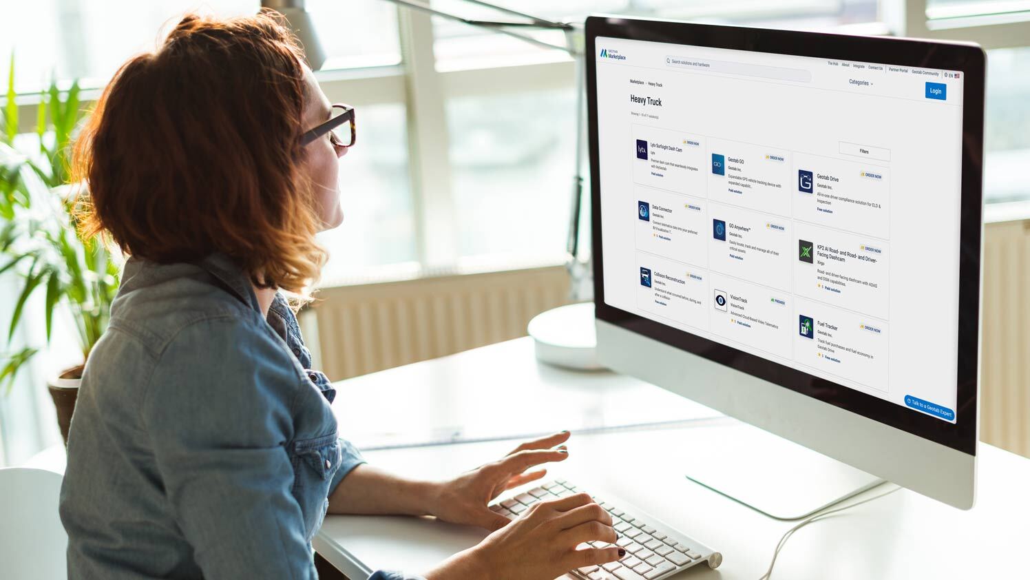 person using computer with Geotab Marketplace on the screen