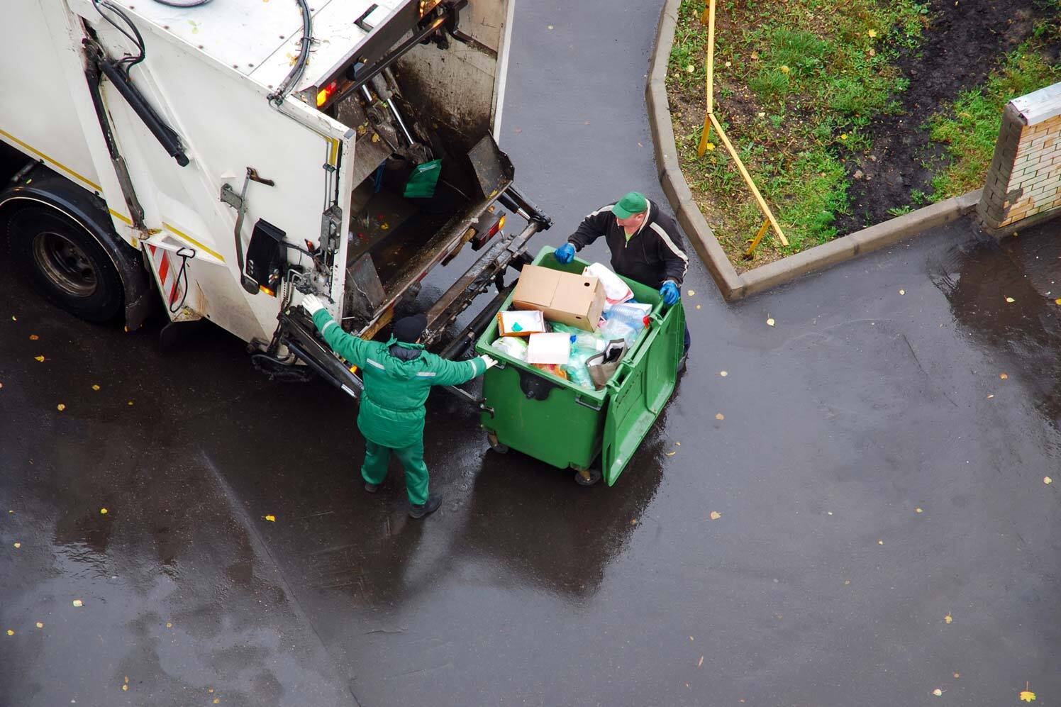 waste and recycling truck being loaded