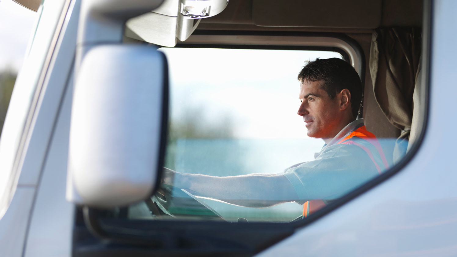 man driving a white HGV truck