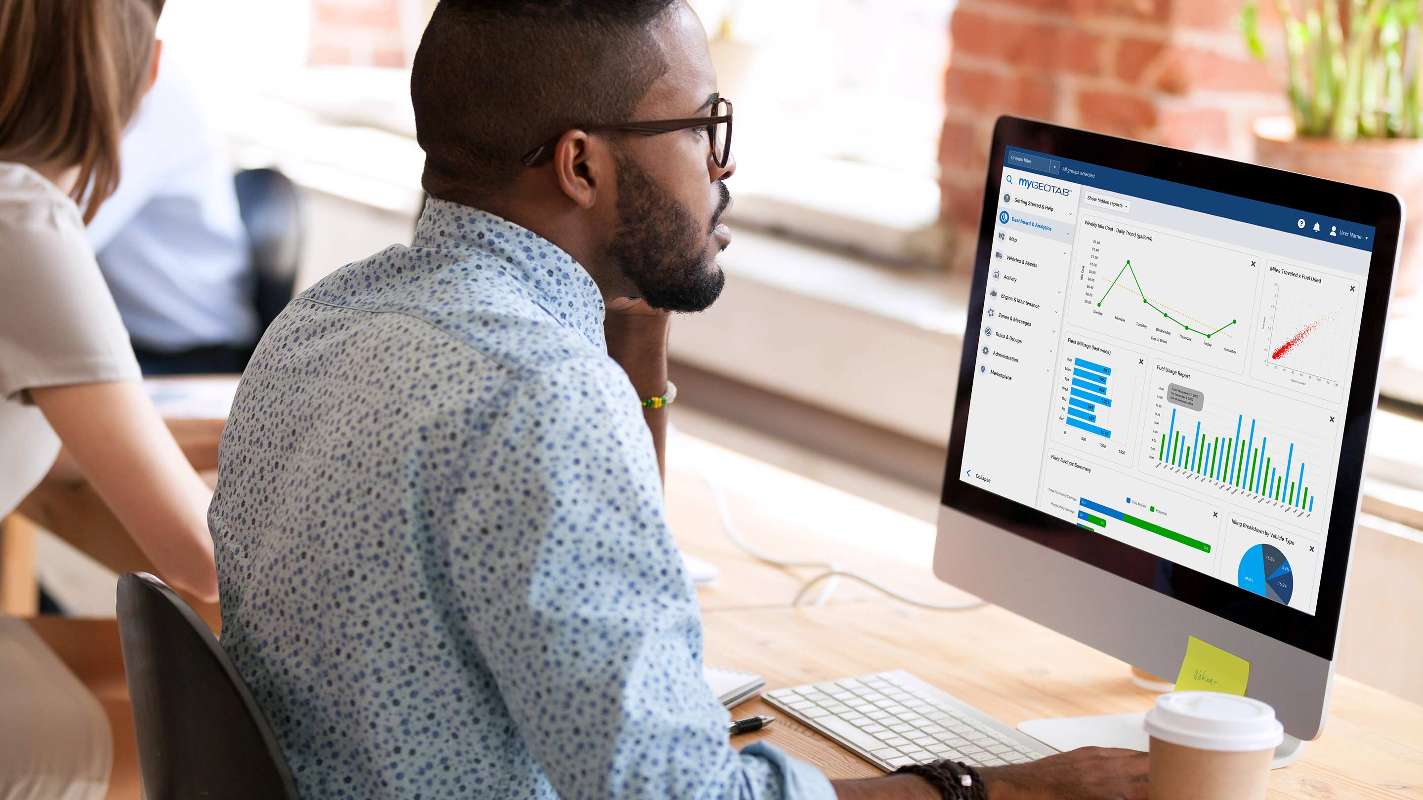 Man using MyGeotab interface on desktop computer