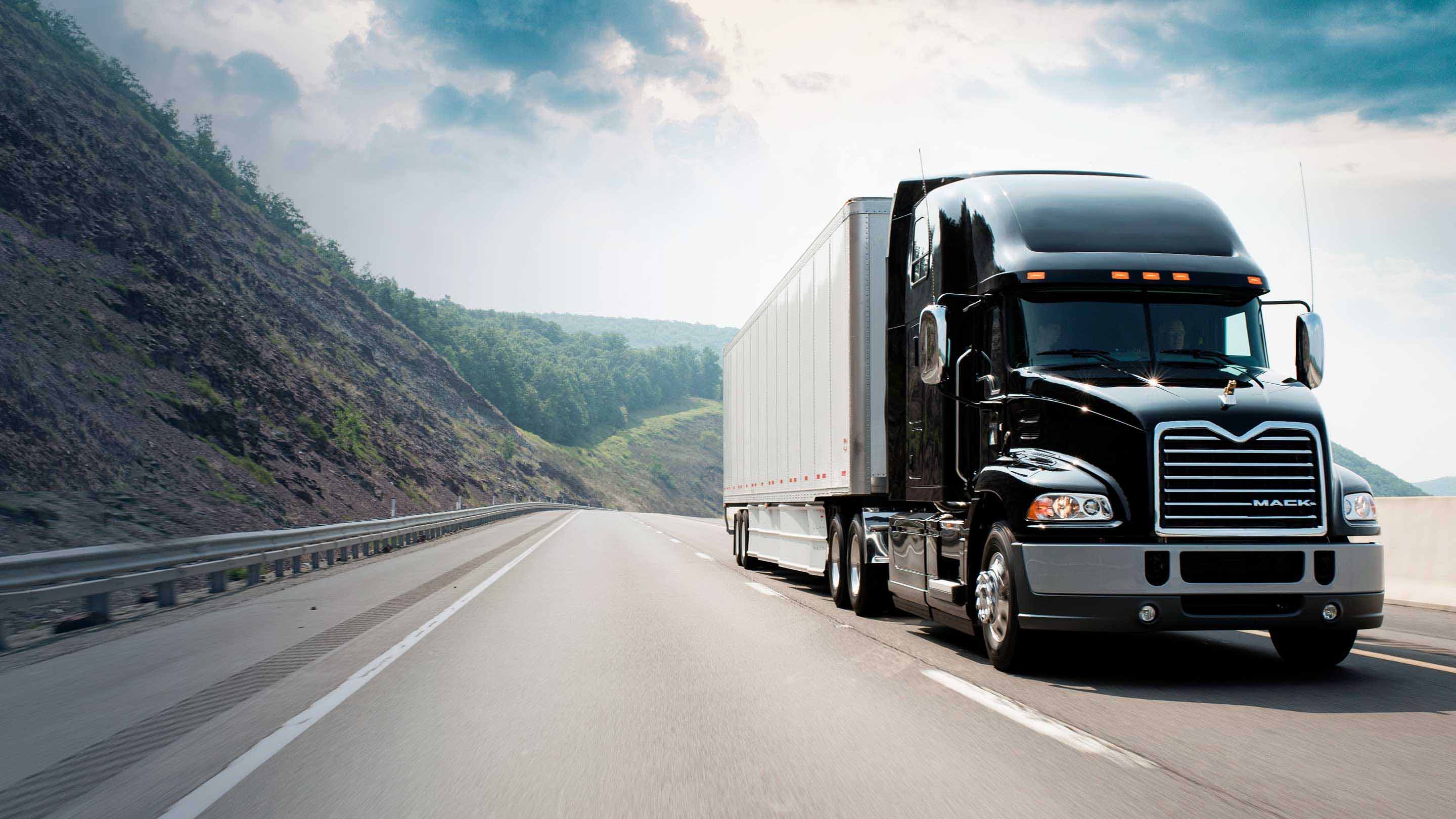 Mack truck driving on road