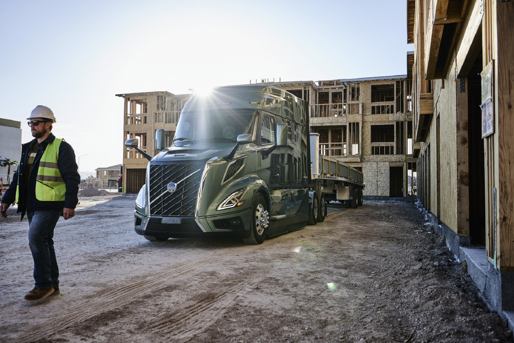 person standing next to a volvo truck