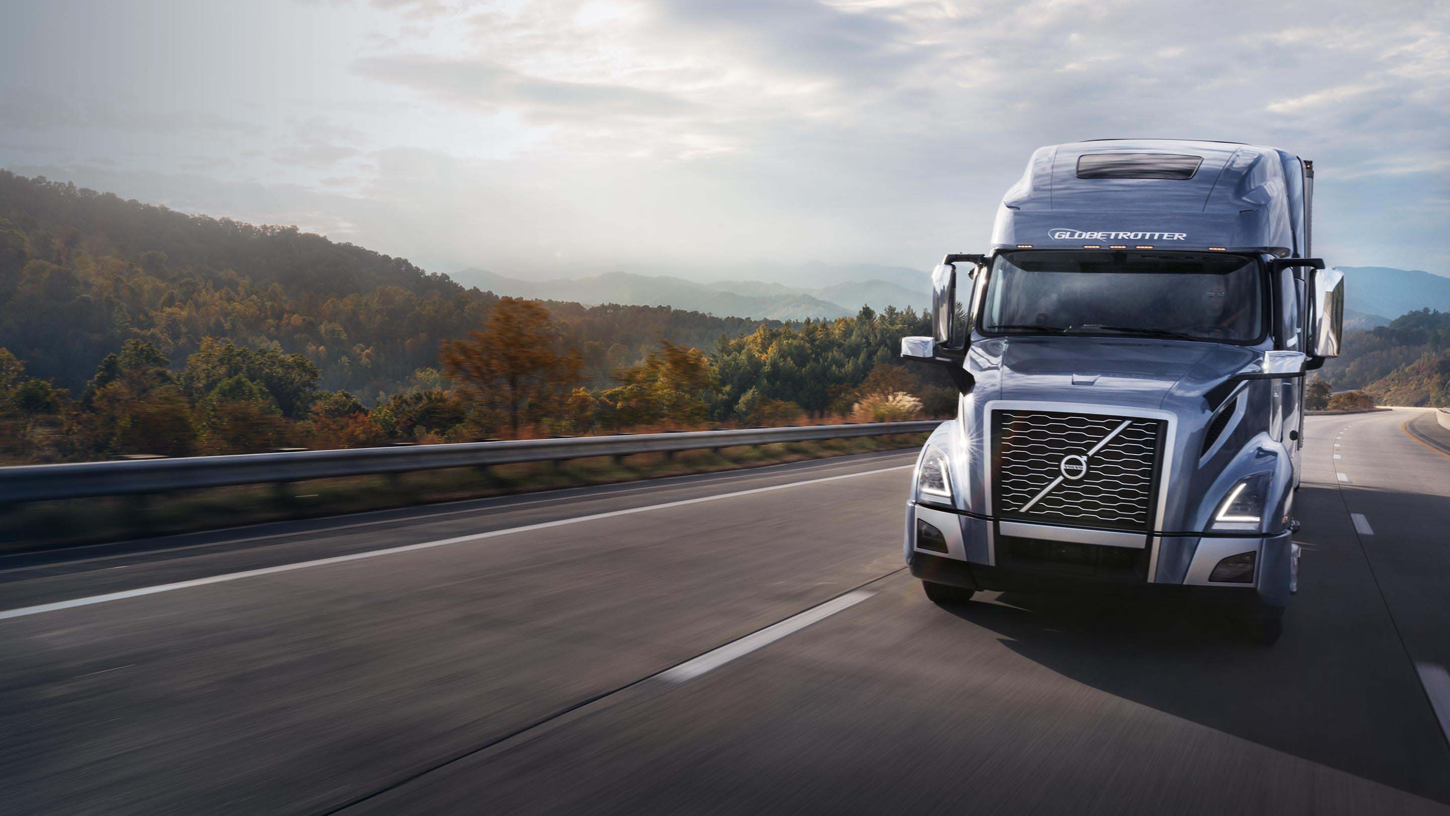 Volvo truck driving on road