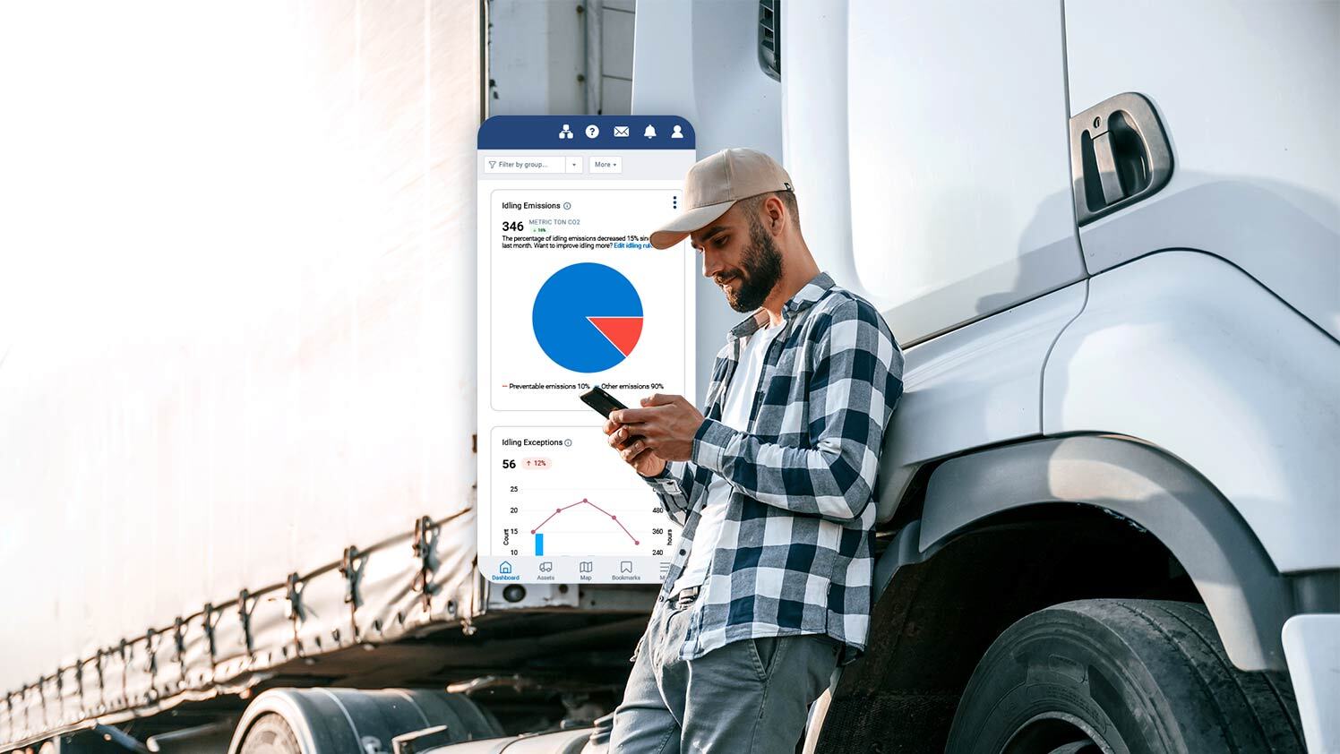 Person standing next to a semi truck using MyGeotab on phone