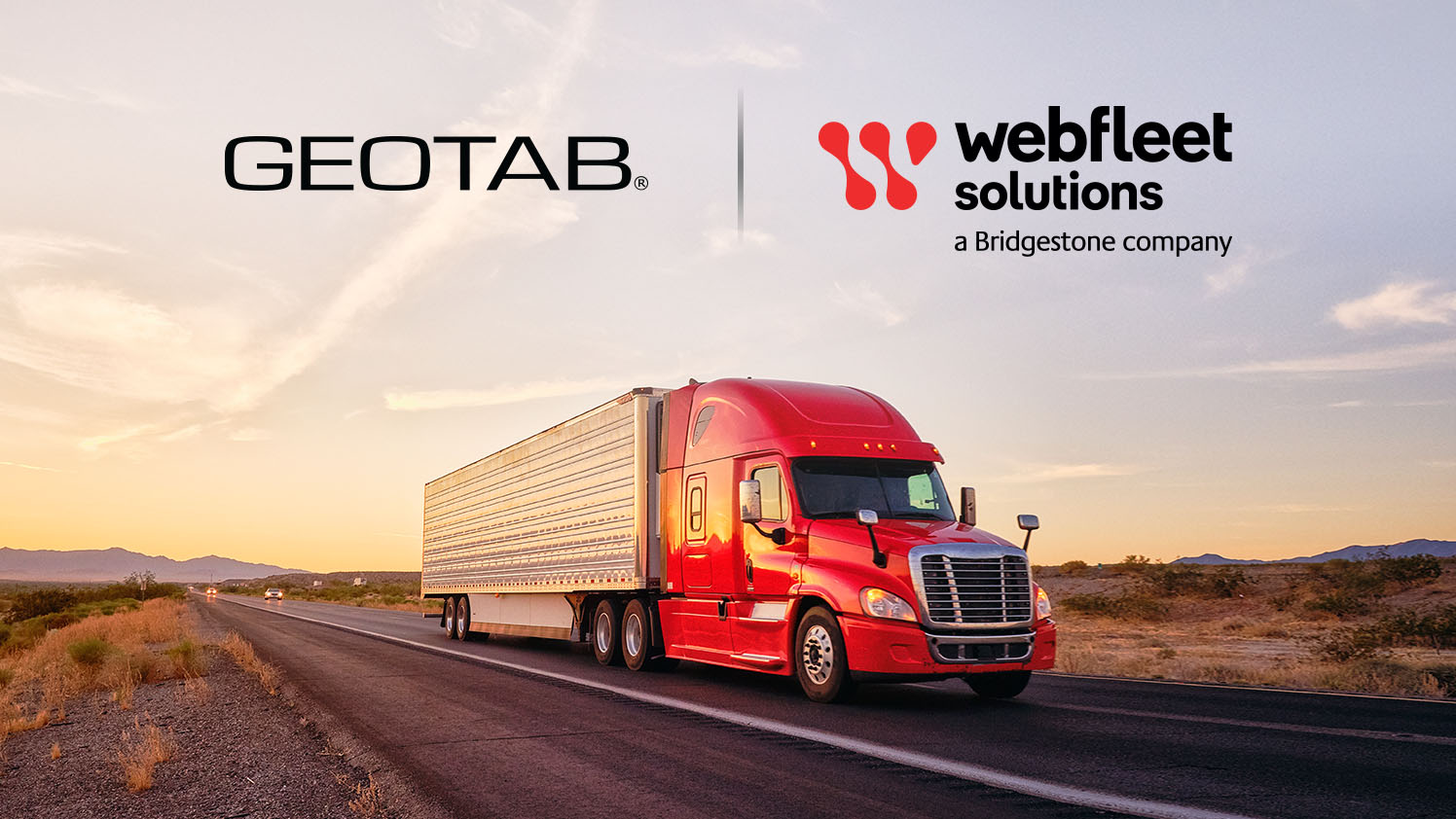 Red truck driving on highway with Geotab logo and Webfleet solutions logo in background