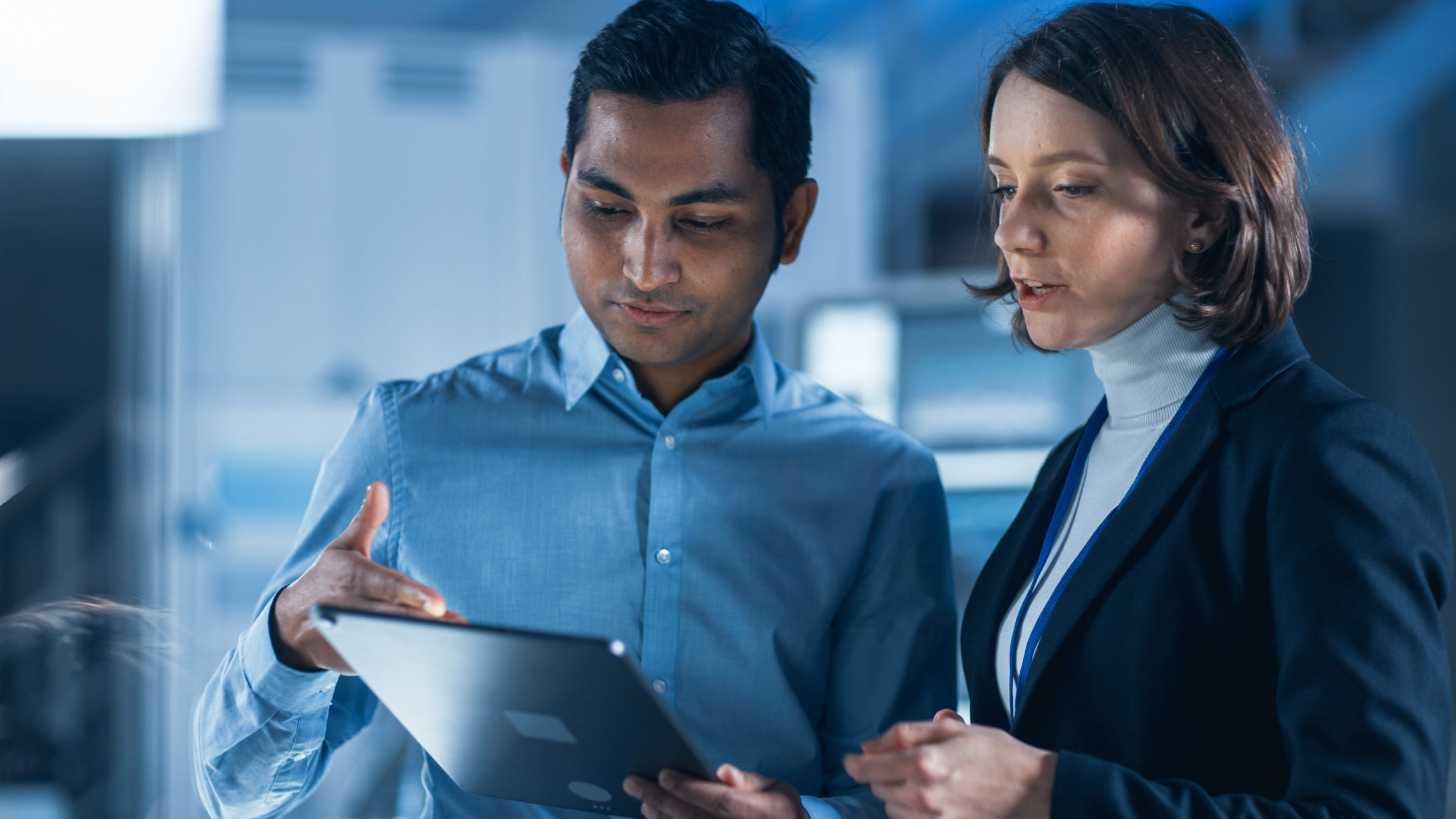 Two people looking at a tablet