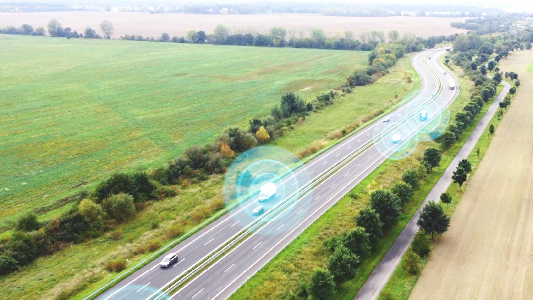 Birdseye view of a highway in the midst of farm land with fleets highlighted in blue to demonstrate connectivity 