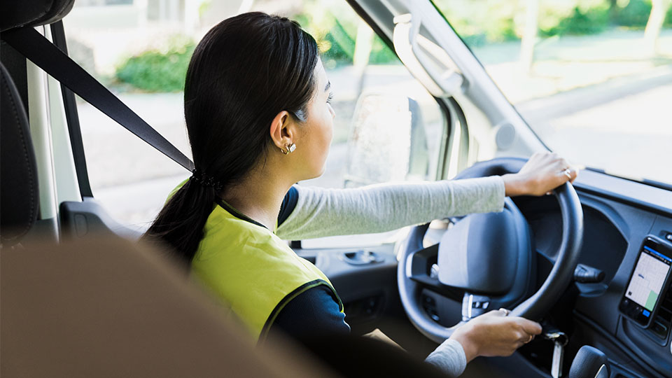 Woman driving a truck in the cab