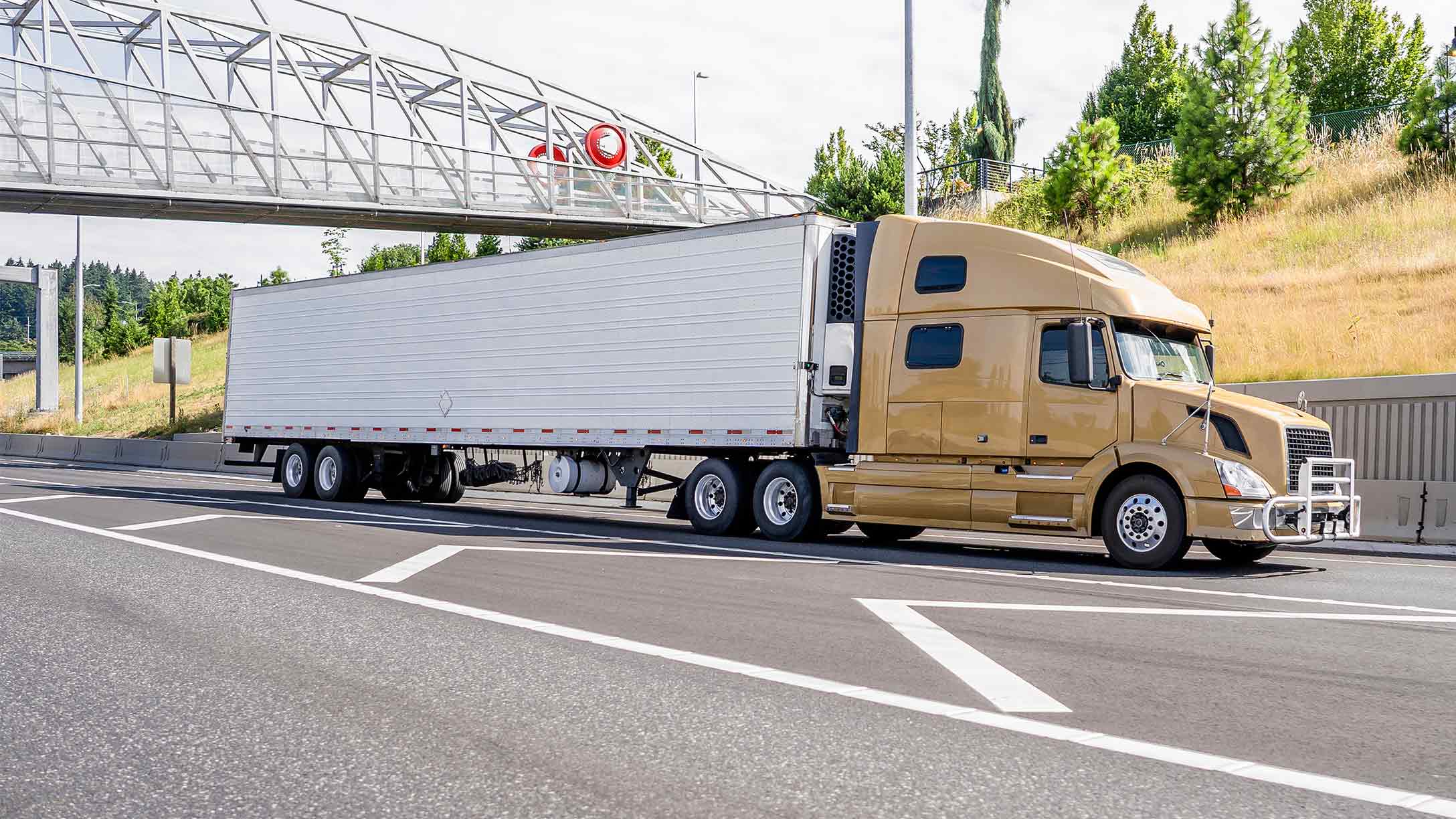 Yellow trailer truck driving on road