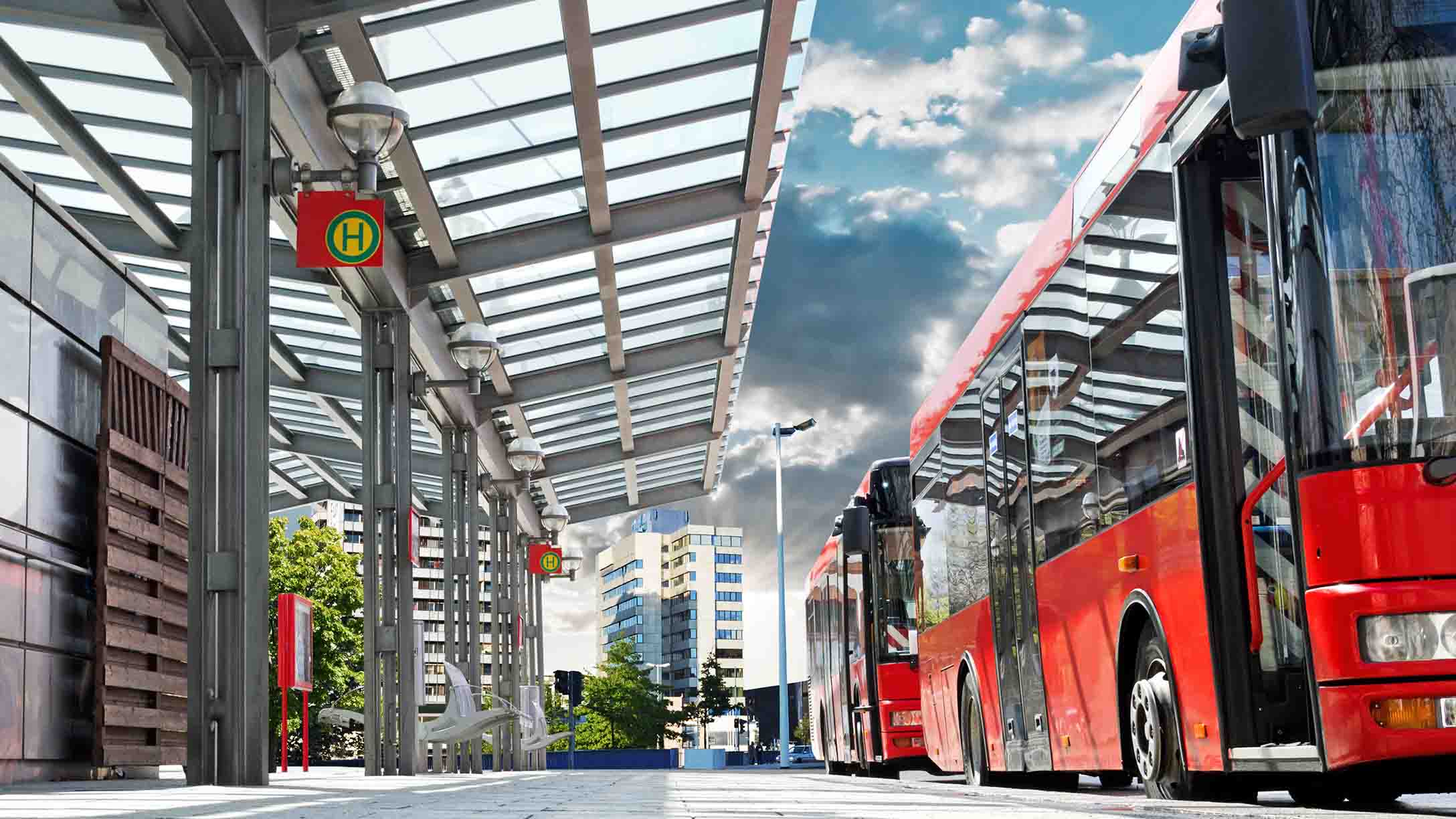 Bus terminal with red busses parked at the front