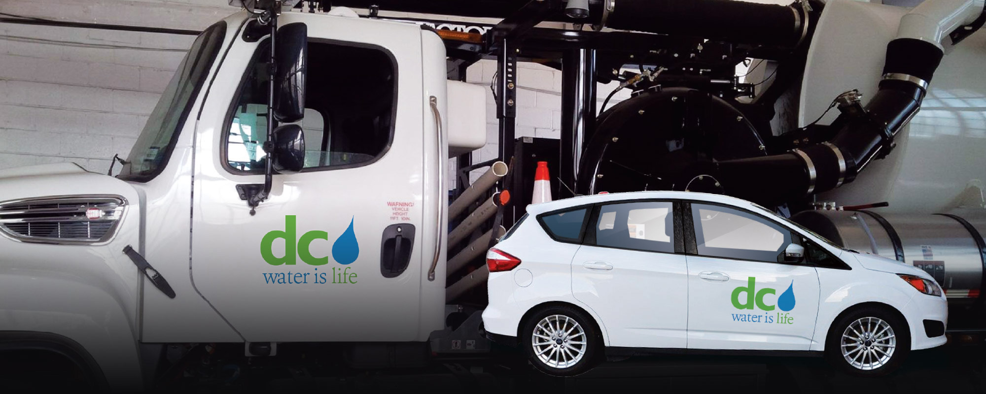 White DC Water truck and car with DC Water logo on the door