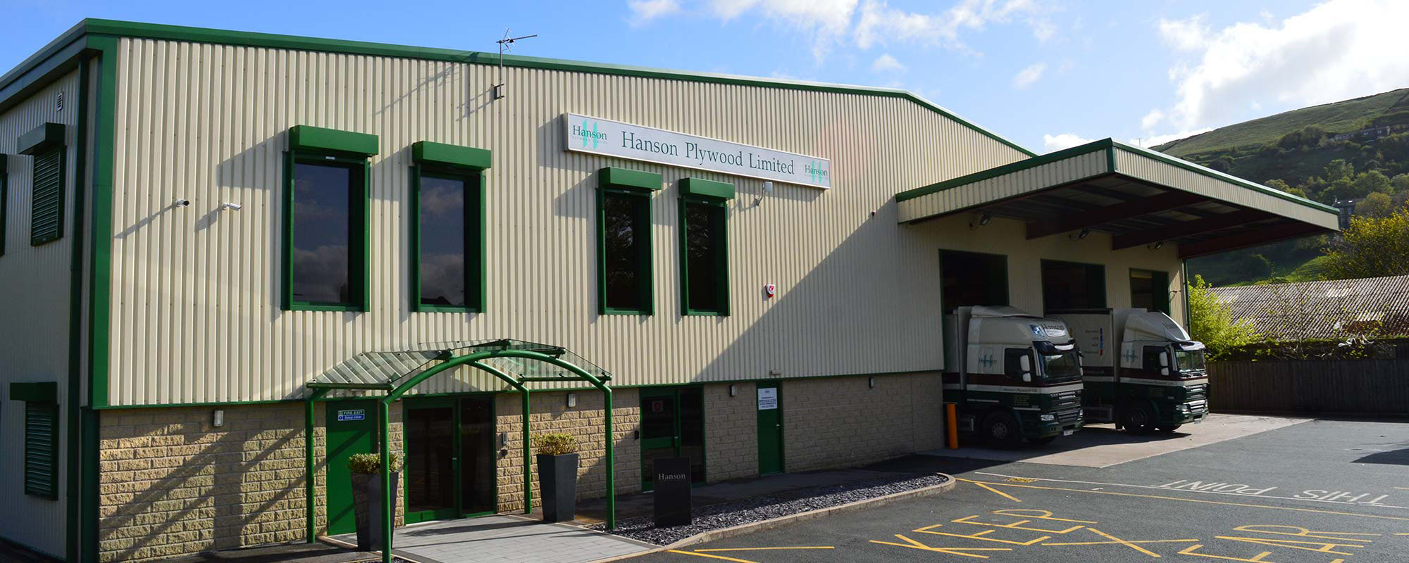 Green and beige building with green entrance awning