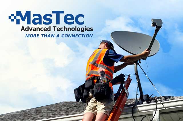 Man wearing an orange safety vest on a roof installing a satellite dish with the MasTec logo in the left hand corner. 