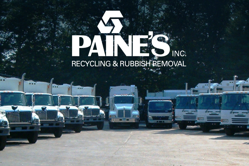 A lineup of white waste and recycling vehicles with PAINE'S logo on top