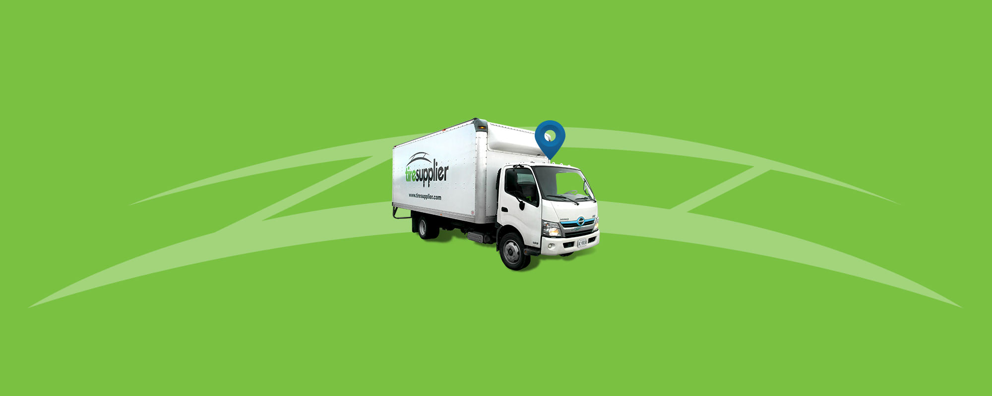 White Tire Supplier truck on a green background with Tire Supplier logo behind it