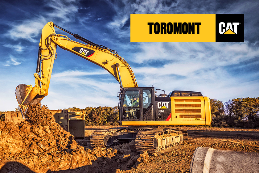 Yellow excavator digging into the ground