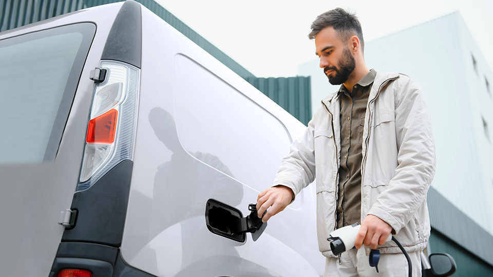 man charging electric truck