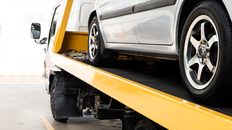 Car on top of tow truckbed