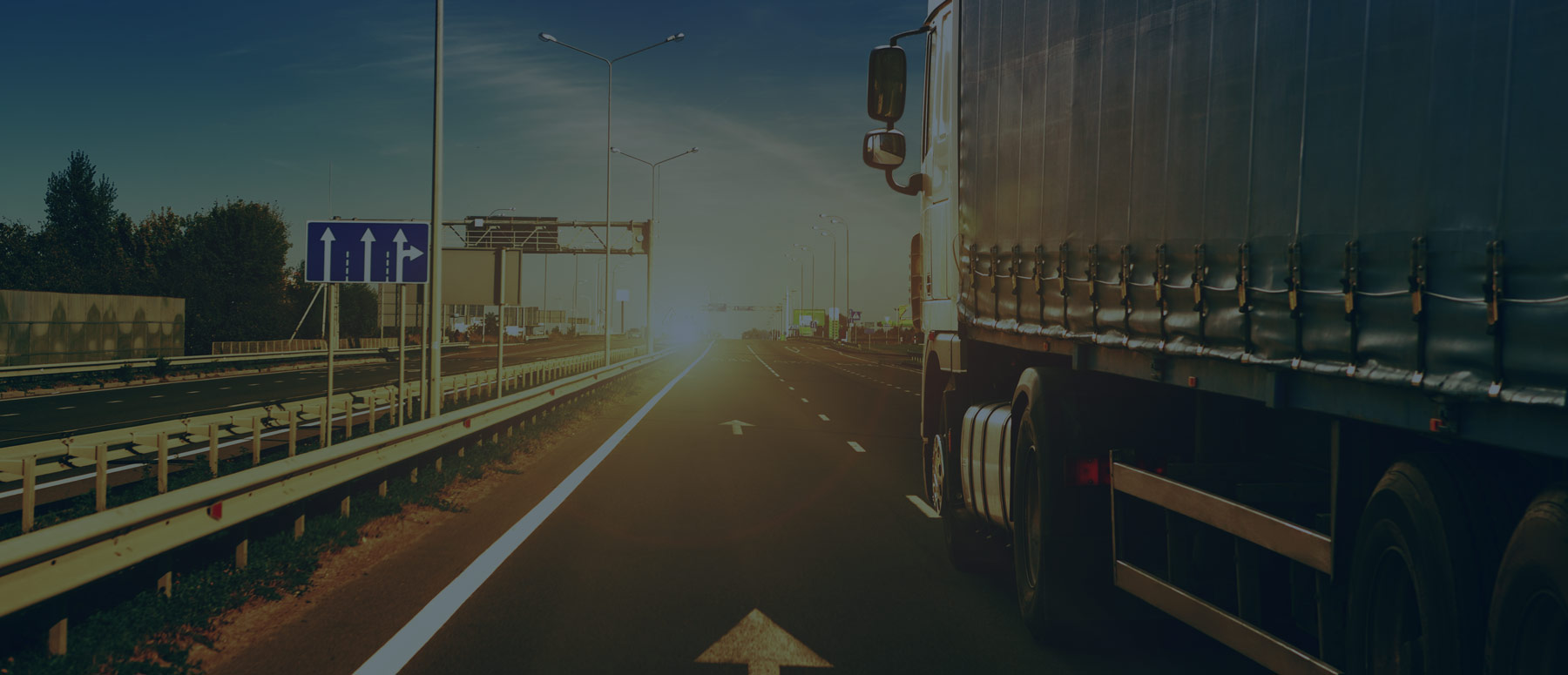 side view of heavy truck driving on road