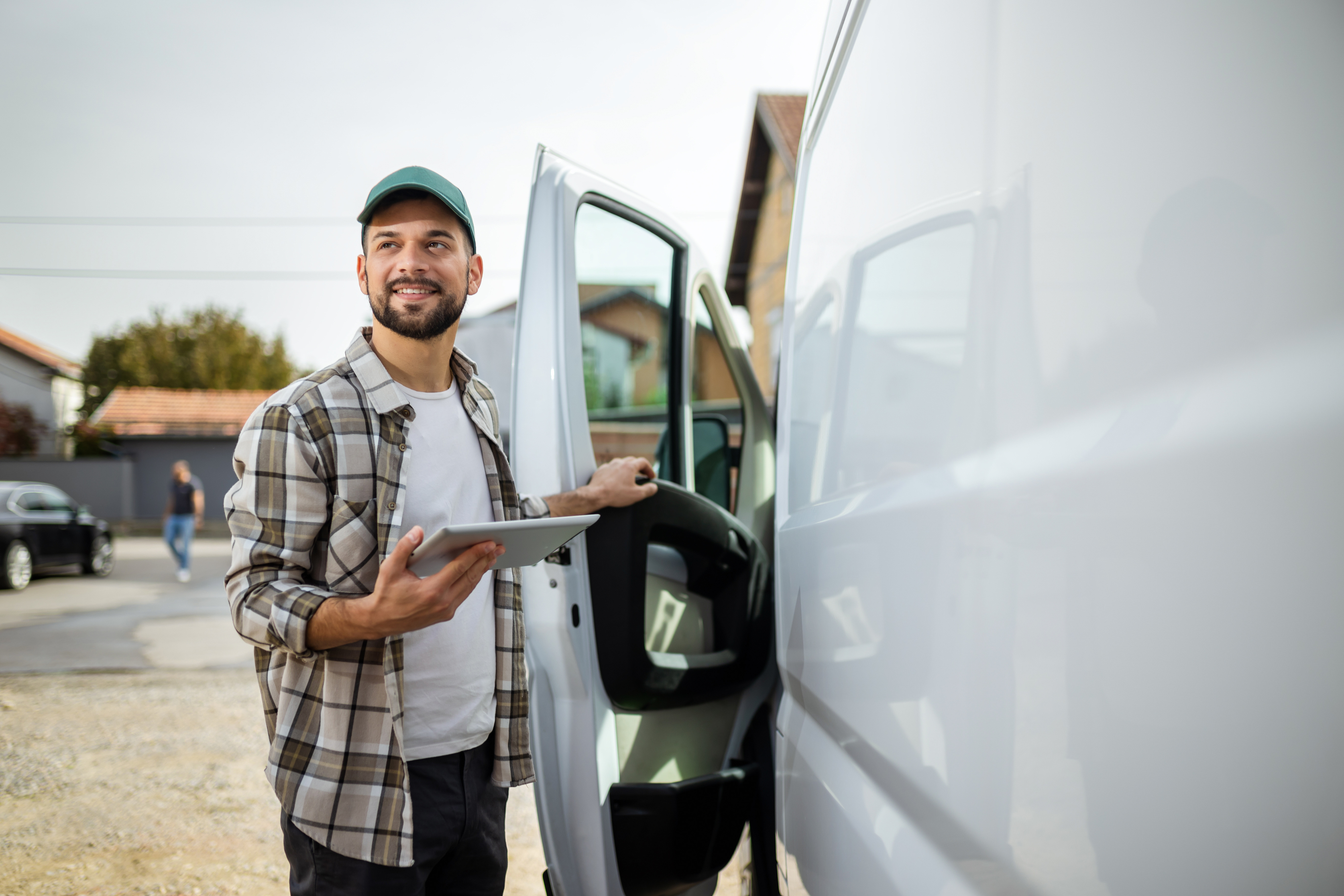 A driver on route with his van and using fleet management.