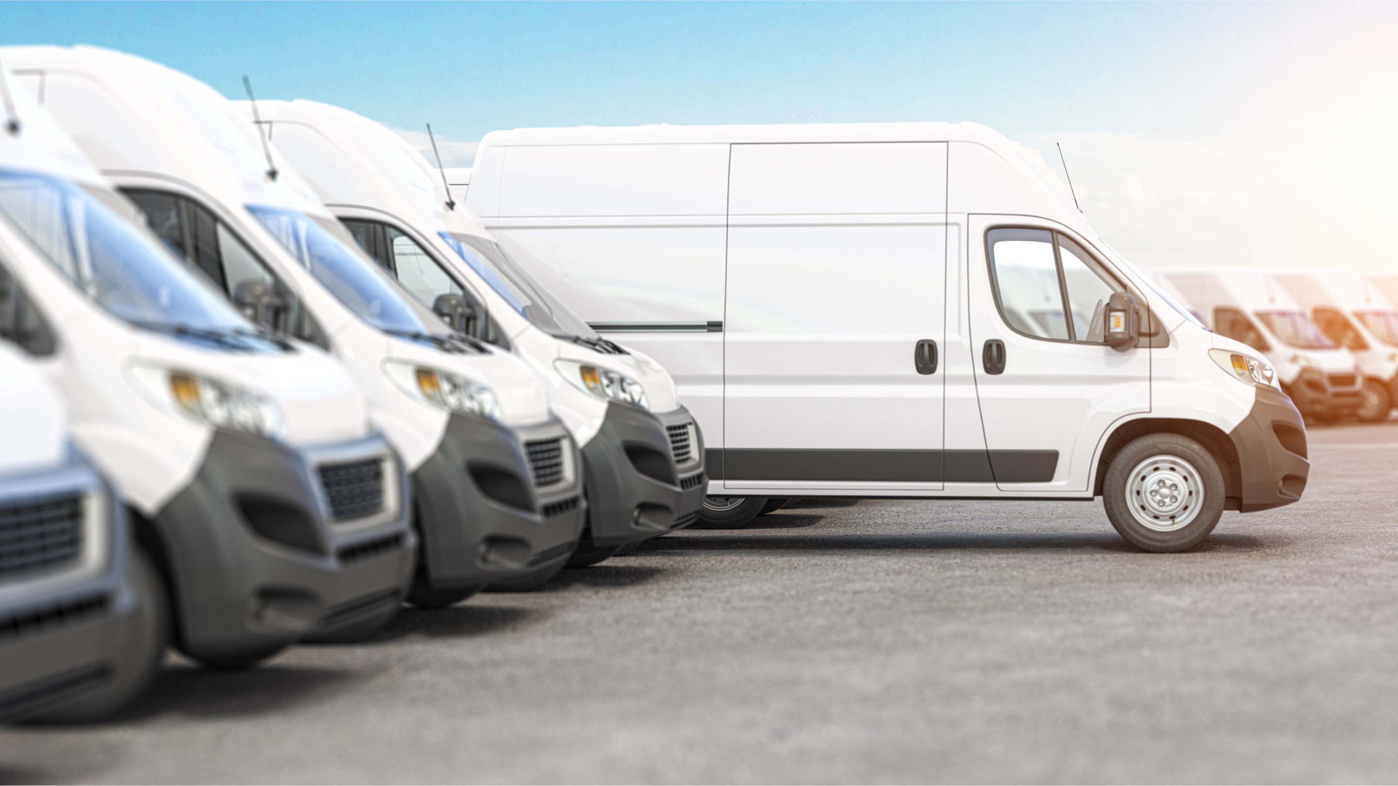 White vans parked beside each other