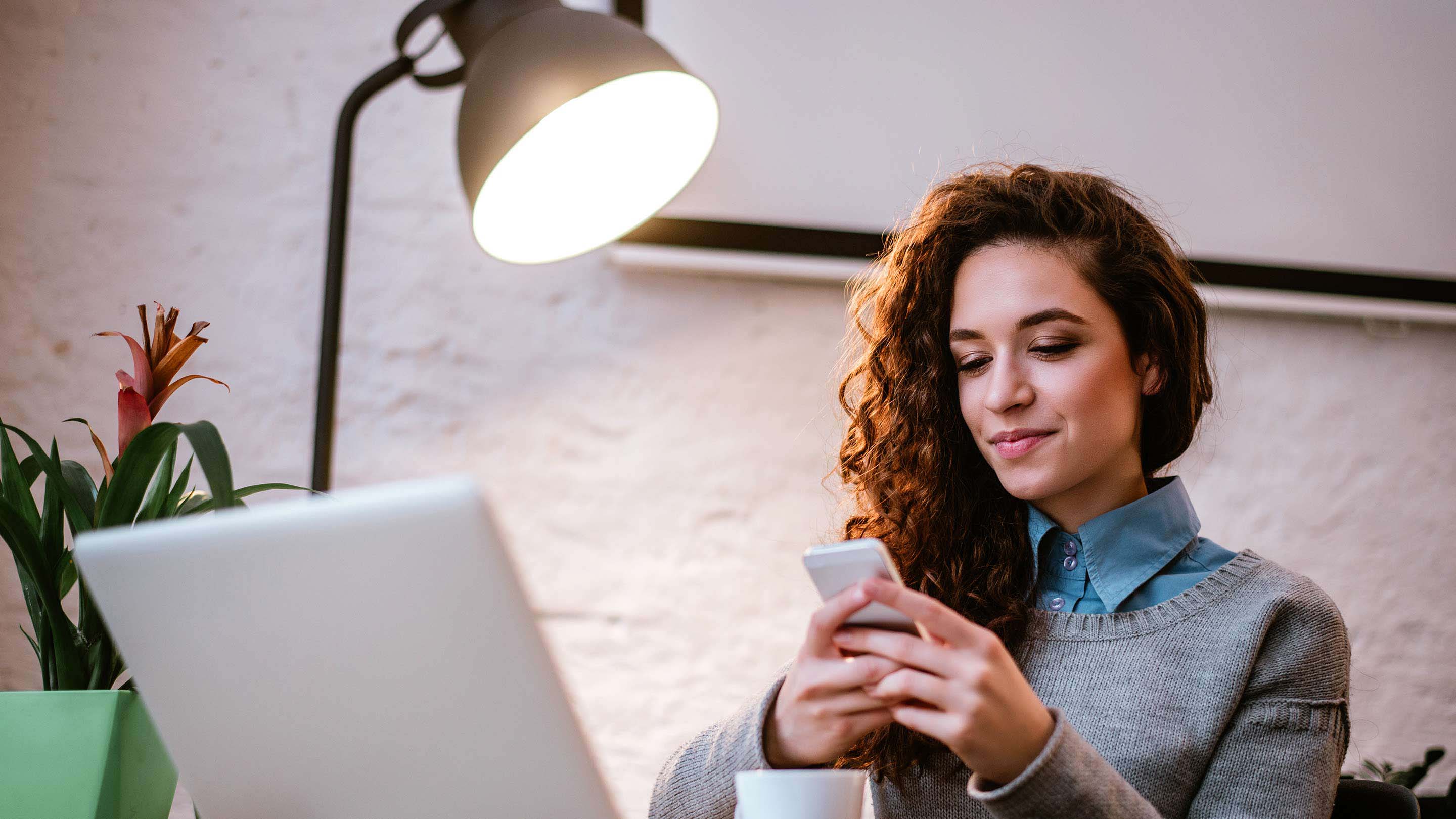 Woman smiling using phone