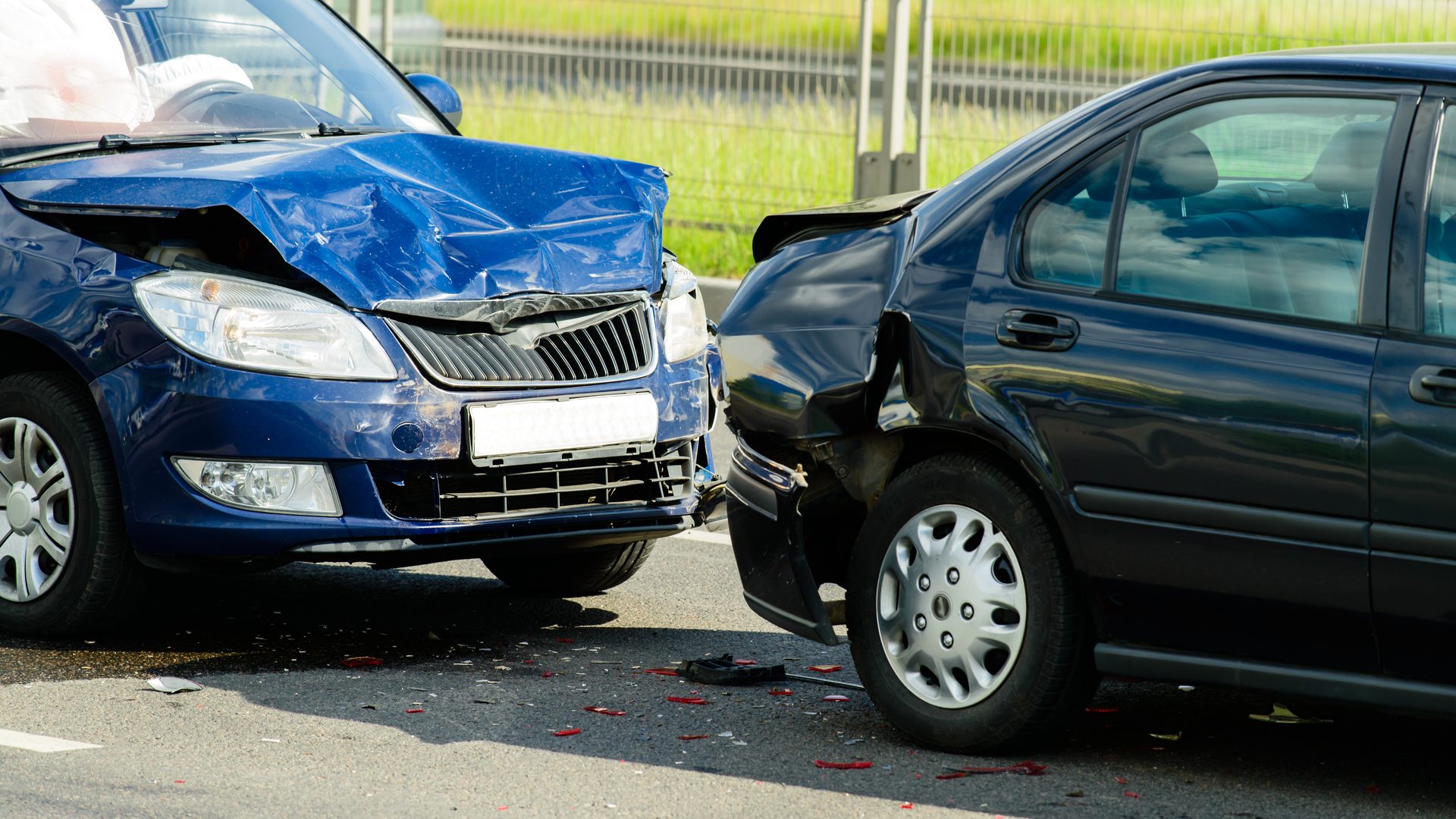 Two cars damaged in a front-to-rear collision on a road
