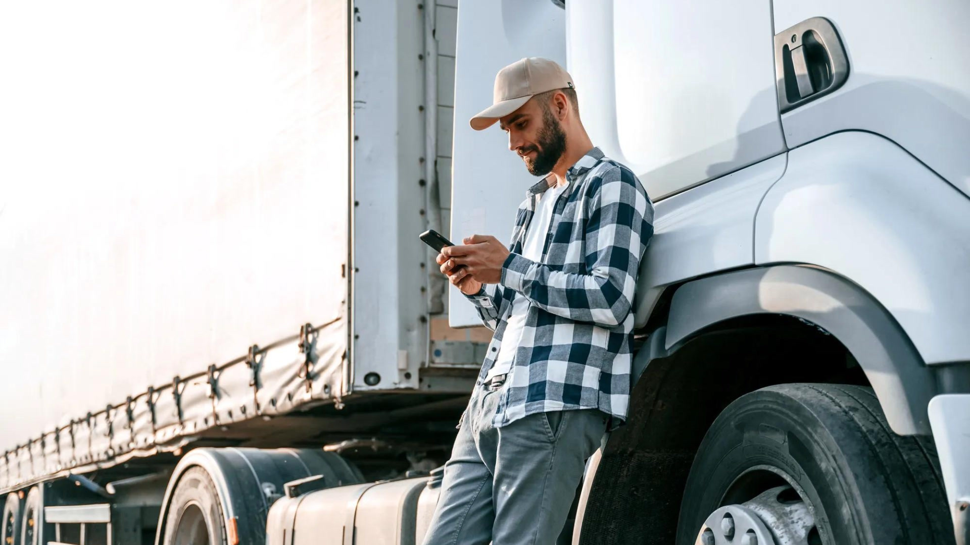 heavy-truck-semi-transport-driver-checking-phone