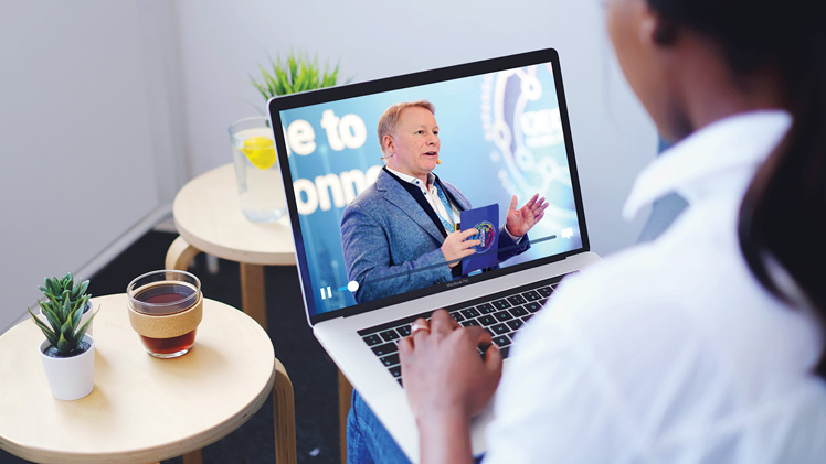 Person watching an online event on their laptop