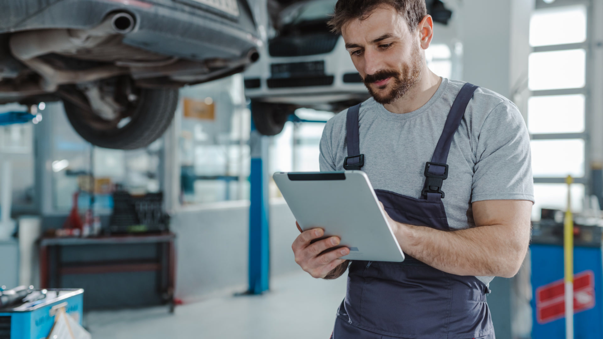 Fleet technician using tablet for predictive vehicle maintenance