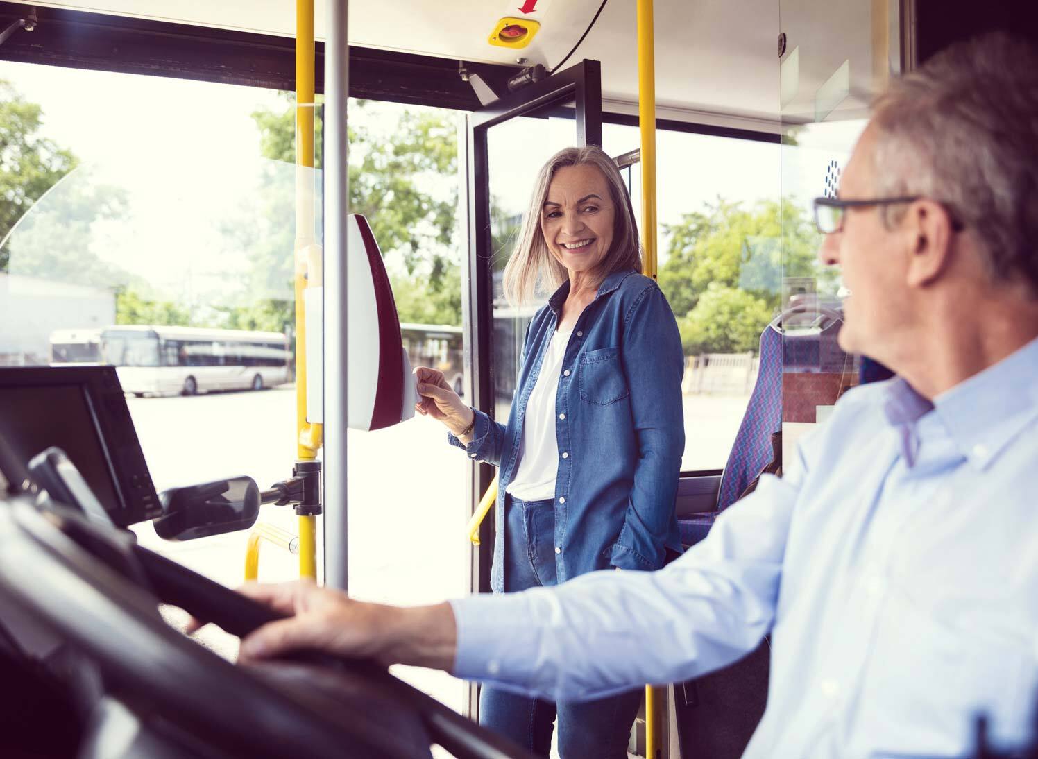 smiling bus driver and passenger