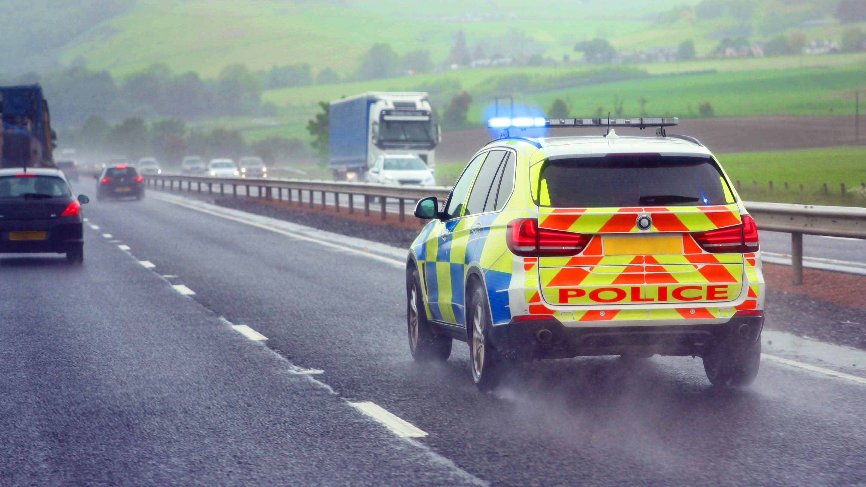 Police car speeding down the street with its lights flashing