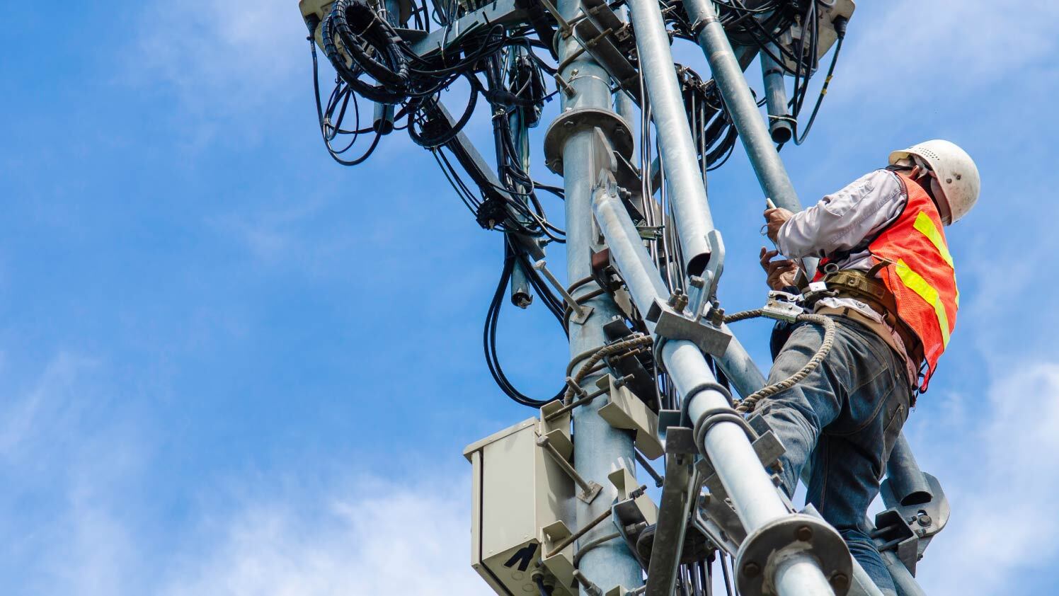 Worker fixing telecommunications tower