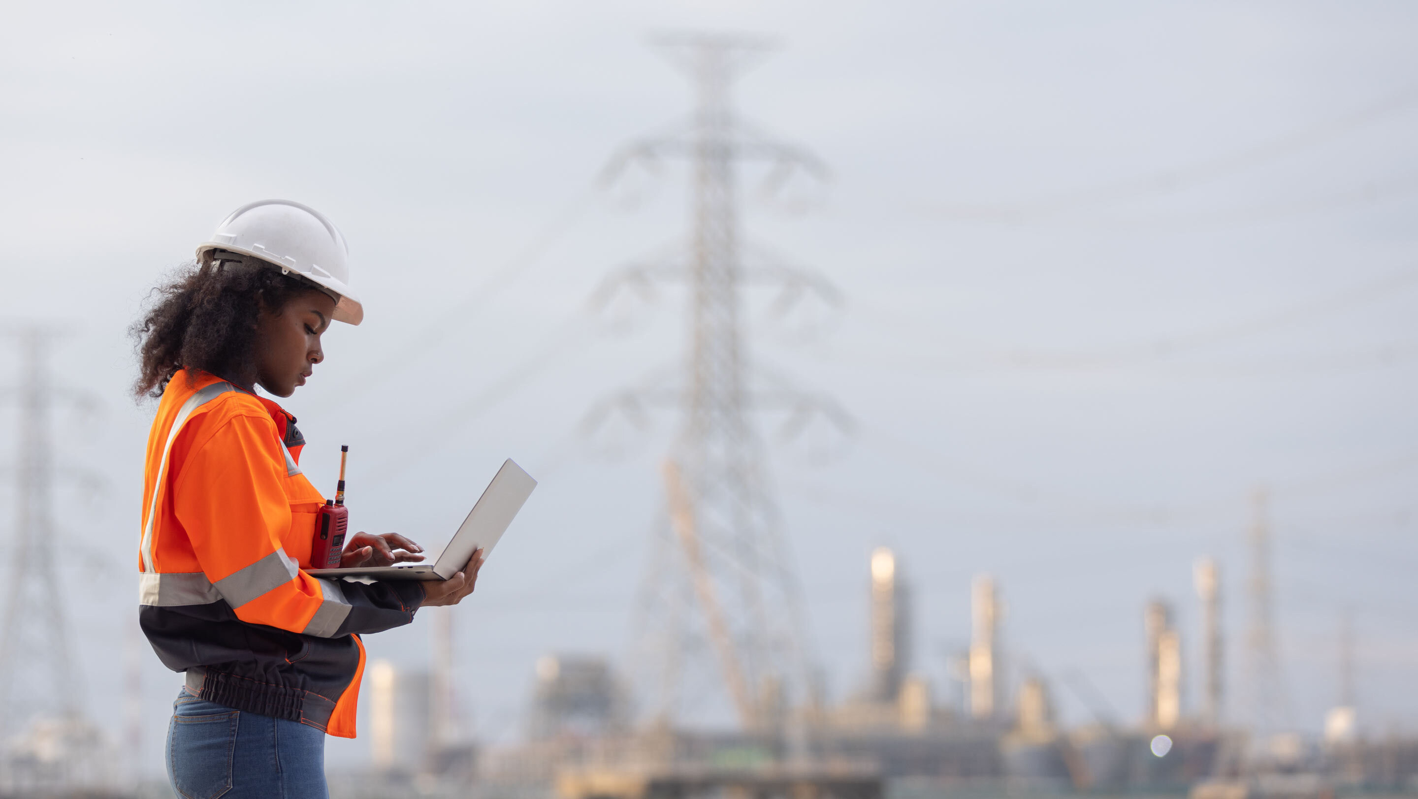 woman construction worker looking at a laptop