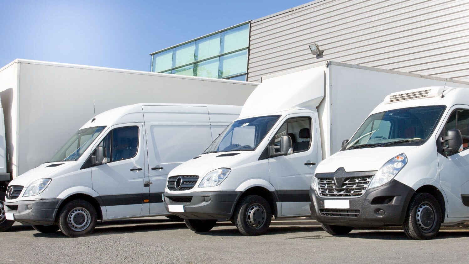 white fleet of vans and trucks