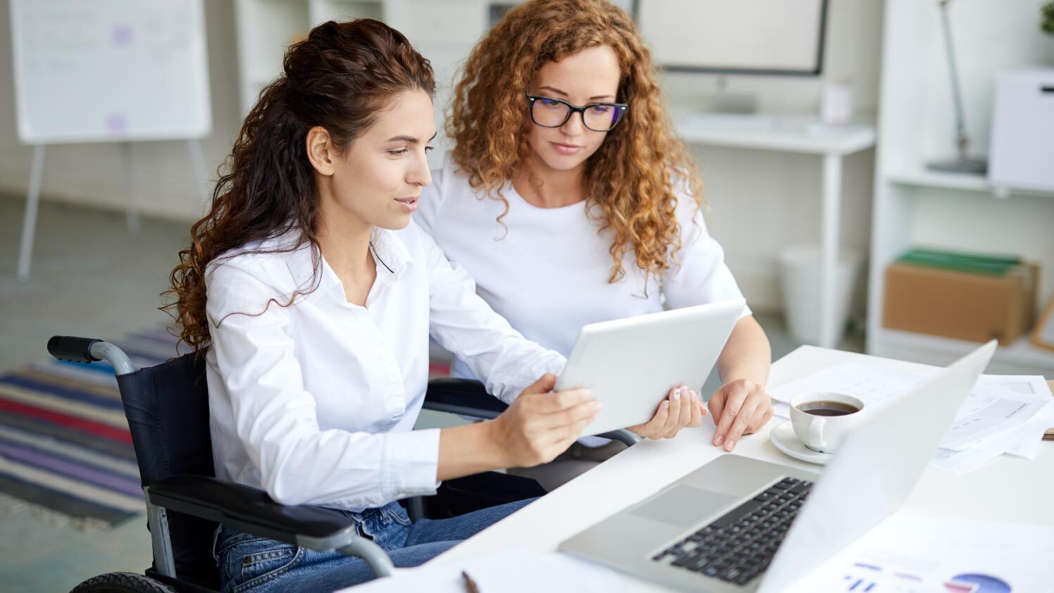 two women sitting at a computer
